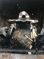 Interior view of a 1959 Jaguar XK150 drophead coupe frame showing storage condition and surface rust.