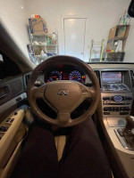 Interior view of a 2009 Infiniti G37 showing the dashboard and steering wheel.
