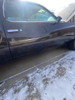 Side view of a classic 1977 Monte Carlo for sale with fresh paint and minimal mileage, showcasing its elegant design.