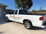 2000 Chevrolet S-10 LS 4WD in white with minor scratches, parked in Florida under palm trees.