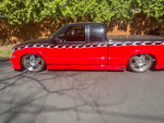 1995 Chevrolet S-10 Xtreme custom pickup truck with flame paint job and chrome wheels parked outdoors