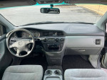 Interior view of a 2001 Honda Odyssey EX showing dashboard, steering wheel, and controls.