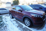 2019 Hyundai Tucson SE FWD parked in snow, showcasing its exterior design and condition, with a focus on resale opportunity.