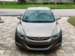 Front view of a 2012 Hyundai Elantra in excellent condition, grey metallic color with manual transmission.