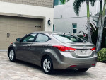 2012 Hyundai Elantra SE in grey metallic parked, showcasing its clean, sleek design and efficient features.