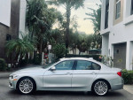 2015 BMW 335 XI AWD in Frozen Silver Metallic parked in a scenic tropical setting
