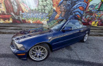 2005 BMW e46 330ci Convertible in Mystic Blue Metallic, showcasing manual transmission and stylish wheels.