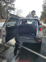 2020 Ford EcoSport Titanium showing spacious trunk with clean interior, in a snowy parking lot.