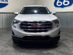 Front view of a 2018 GMC Terrain SLT FWD in a showroom, showcasing its sleek design.