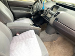 Interior view of a 2005 Toyota Prius hatchback showing the front seats and dashboard.