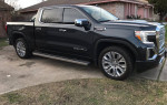 2022 GMC Sierra 1500 Denali 4WD parked in pristine condition with a sleek black exterior.