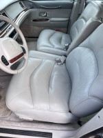 Interior view of a 1995 Lincoln Towncar with gray leather seats and modern dashboard features.