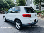 2015 Volkswagen Tiguan SE 4Motion AWD in white with black leather interior, parked in a residential area.
