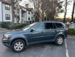 2007 Volvo XC90 3.2 AWD in blue with black leather interior, parked in a residential area.
