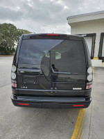 Rear view of a 2016 Land Rover LR4 HSE luxury SUV in black with clear taillights