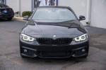 2020 BMW 430i xDrive Coupe in Black Sapphire Metallic, showcasing its sleek design and advanced headlights.