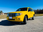 Yellow 2011 Ford Escape with 105,000 miles, spacious and perfect for family or work needs.