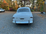 1949 Ford Custom 2 Door Sedan with Flathead V8, in excellent condition parked outdoors among colorful autumn leaves.