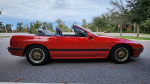 1988 Mazda RX7 convertible in excellent condition parked on a street, showcasing clean body and wheels.