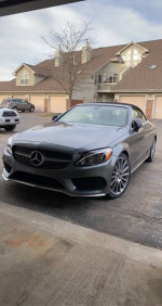 2017 Mercedes-Benz C300 Cabriolet in Selenite Grey Metallic parked in a driveway.