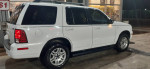 2005 Mercury Mountaineer in white, featuring beige interior and all-wheel drive, ideal for deliveries.