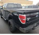 2011 Ford F150 XLT 4x4 black pickup truck with bed cover and clean interior, low mileage, and parking sensors.