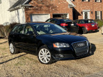 Black 2009 Audi A3 Quattro hatchback parked on grass, showcasing its sporty design and low mileage.