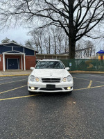 Well-maintained white 2006 Mercedes-Benz C230 parked in a clean area, first owner since 2007.