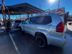 2003 Lexus GX 470 SUV parked at gas station, featuring a clean title and Dobinsons 3 inch lift
