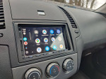 Car dashboard showing Android Auto and climate controls, highlighting tech features and clean interior.