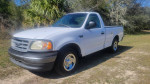 2001 Ford F150 regular cab with low mileage parked outdoors, featuring new tires and recent maintenance.