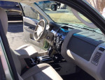 Interior view of a 2010 Ford Escape Limited featuring leather seats and modern dashboard controls.