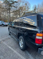 2001 Chevrolet Suburban parked, showcasing its clean exterior and good condition with new tires.