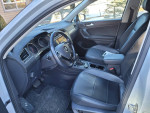 Interior view of a 2018 Volkswagen Tiguan SEL with black leatherette seats and modern dashboard features.