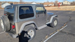 2002 Jeep Wrangler parked in a lot, showcasing great condition and reliable performance.