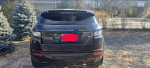 Rear view of a 2013 Land Rover Range Rover Evoque in black, parked in a public area.