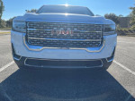 Front view of a 2021 GMC Acadia SLE in excellent condition with 52,000 miles, showcasing its stylish grille and bumper.