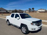 2010 Honda Ridgeline 4WD, white color, parked on a street in Leander, TX, showcasing its clean exterior and chrome details.
