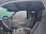 Interior view of a 1996 Chevrolet Silverado 1500 with new seats and remote start, showcasing the dashboard and seating.