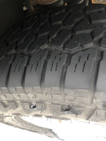 Close-up of a tire showing tread depth on a 2006 Tundra Limited with high mileage.