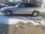 2001 Lincoln Town Car Signature RWD in pristine condition with low mileage and leather interior, parked on snowy ground.