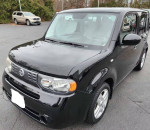 2010 Nissan Cube SL in black with keyless start and reverse camera, showcasing new tires and economical design.