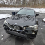2017 BMW X3 xDrive28i in black, parked in snowy area, showing minor dents and scratches.