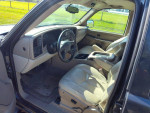 Interior of a 2006 GMC Yukon XL K1500 with leather seats and dashboard showing mileage and controls.