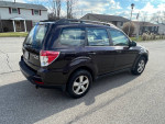 2013 Subaru Forester with 80,000 miles parked on a residential street, showcasing its design and condition.