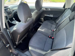 Interior view of a 2013 Subaru Forester showcasing rear seating and cabin quality
