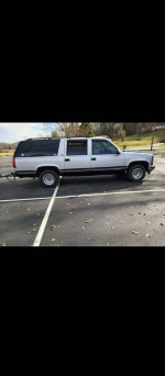 1994 GMC Suburban in a parking lot, dependable SUV with new parts, great for winter driving.