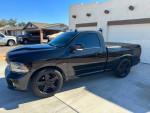 Black 2015 Ram 1500 R/T with supercharger, 22-inch wheels, and no mileage issues, parked in driveway.