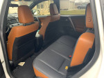 Interior view of a 2016 Toyota RAV4 SE with tan and black seating, highlighting clean condition and spacious rear seats.