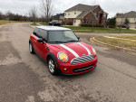 2013 Mini Cooper in excellent condition with 79,800 miles, showcasing its sleek red exterior and stylish design.